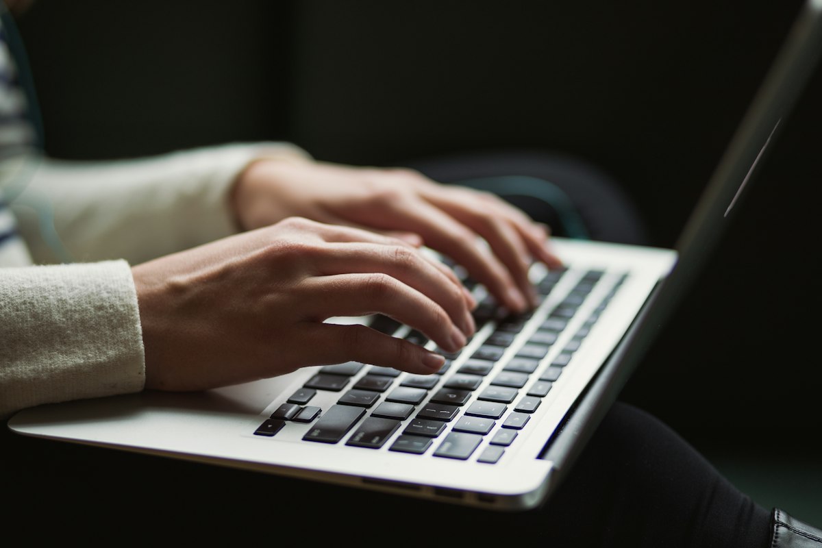 Hands typing on a keyboard